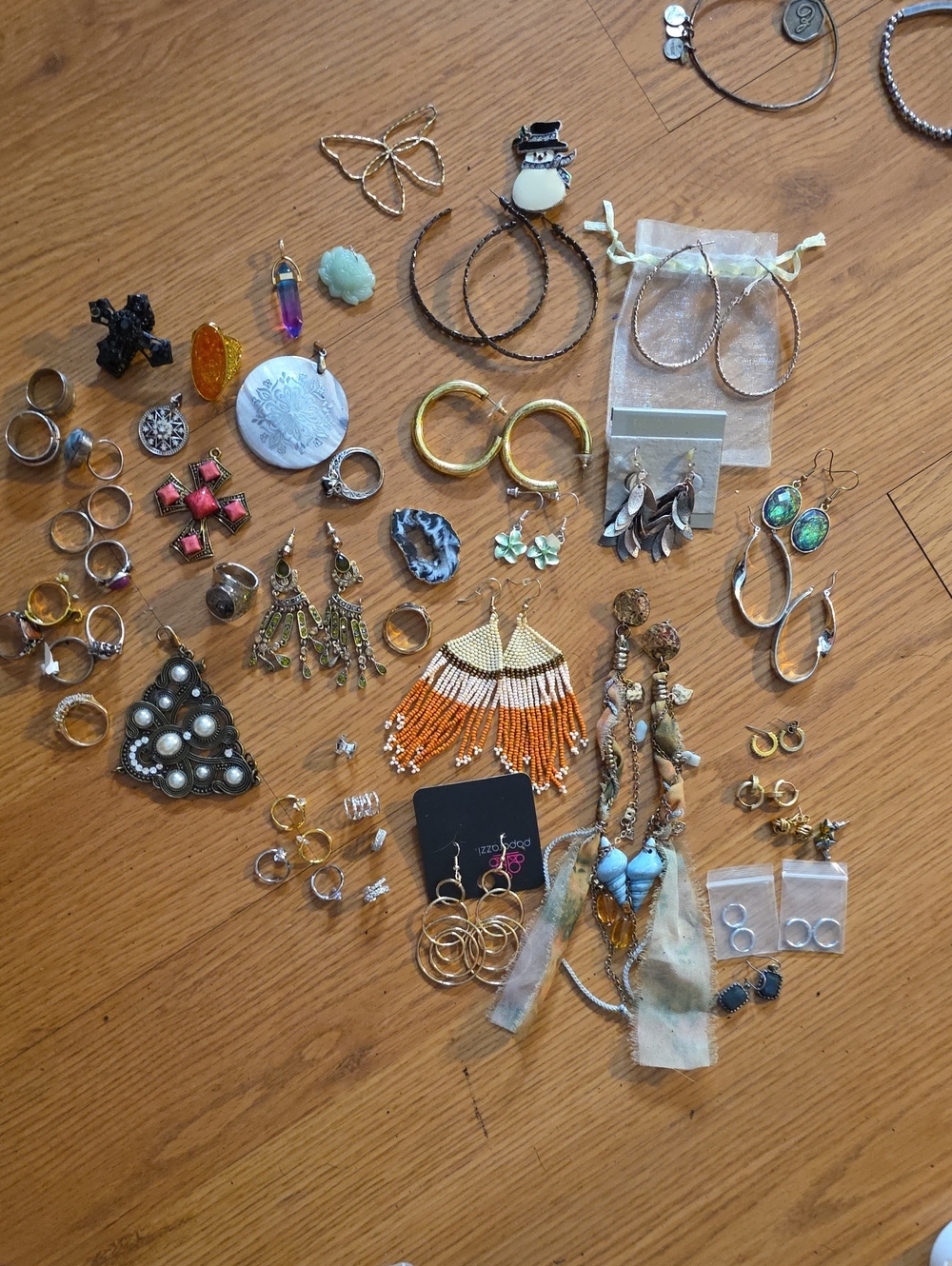 Assorted Women's Earrings And Rings In Various Colors And Sizes